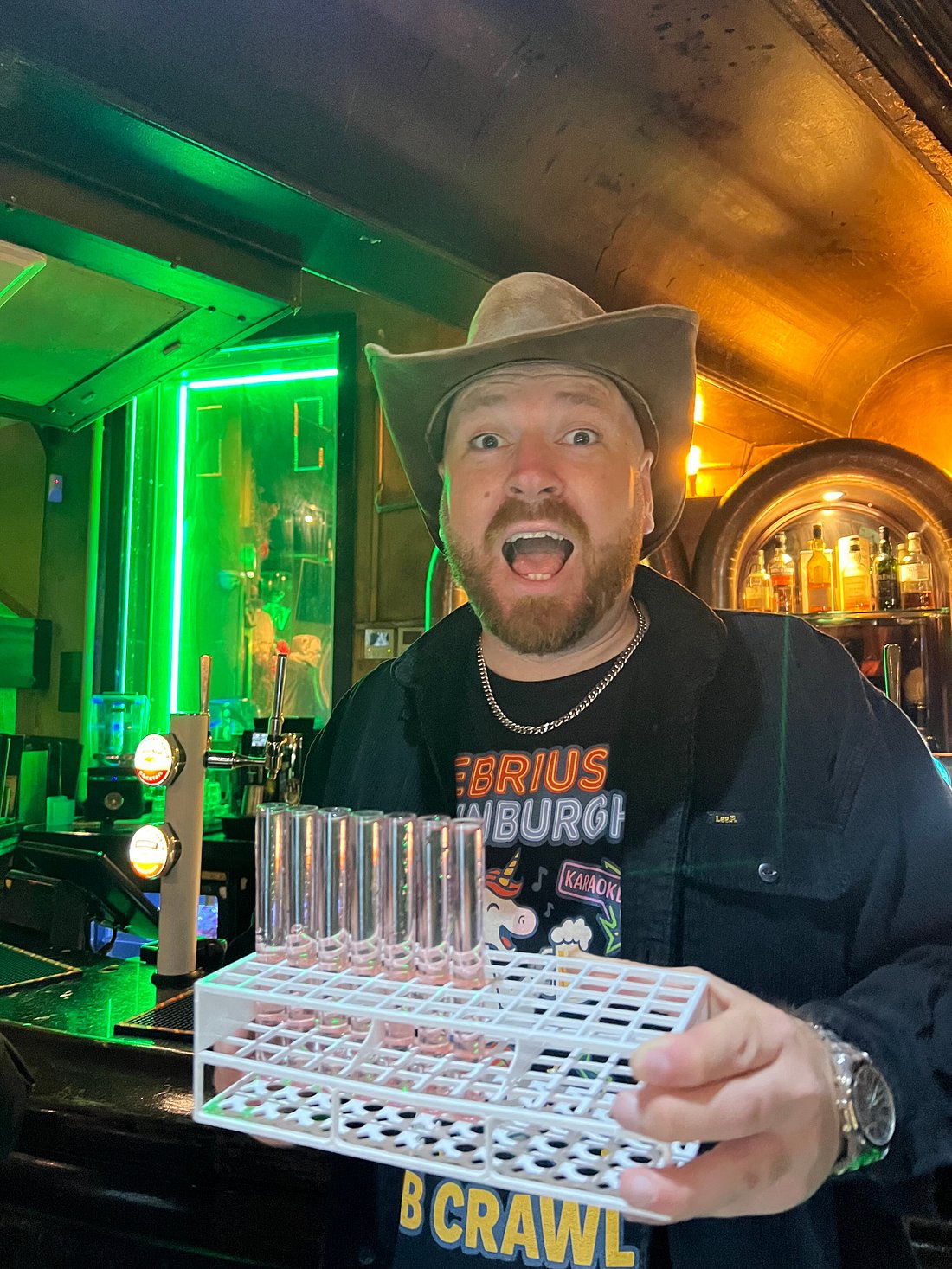 A cowboy serving shots of alcohol